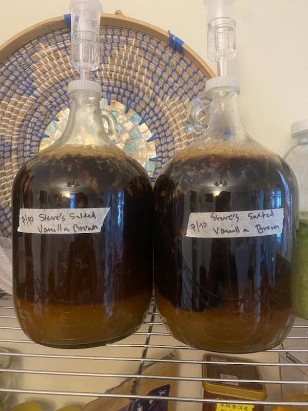 two 1-gallon fermentors filled with brown ale